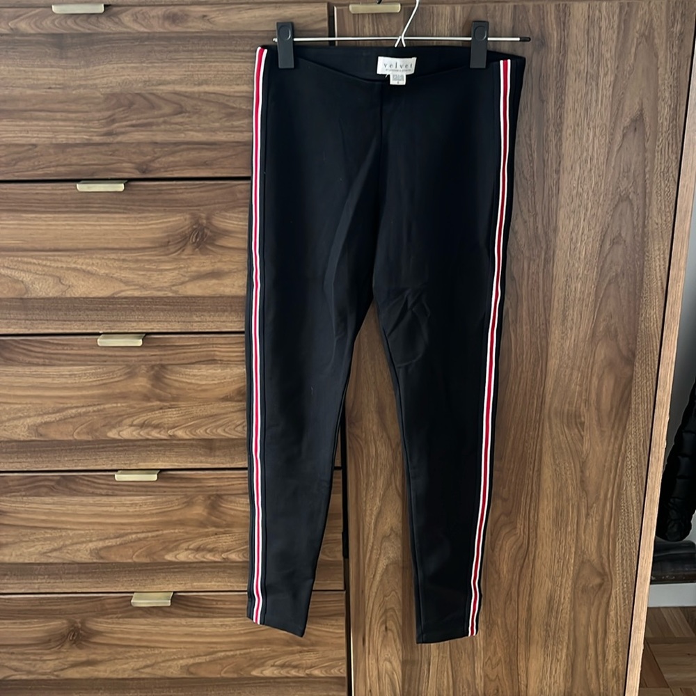 Black cotton pant with red and white stripe down leg.